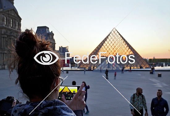 Turist fotograferer Louvremuseet